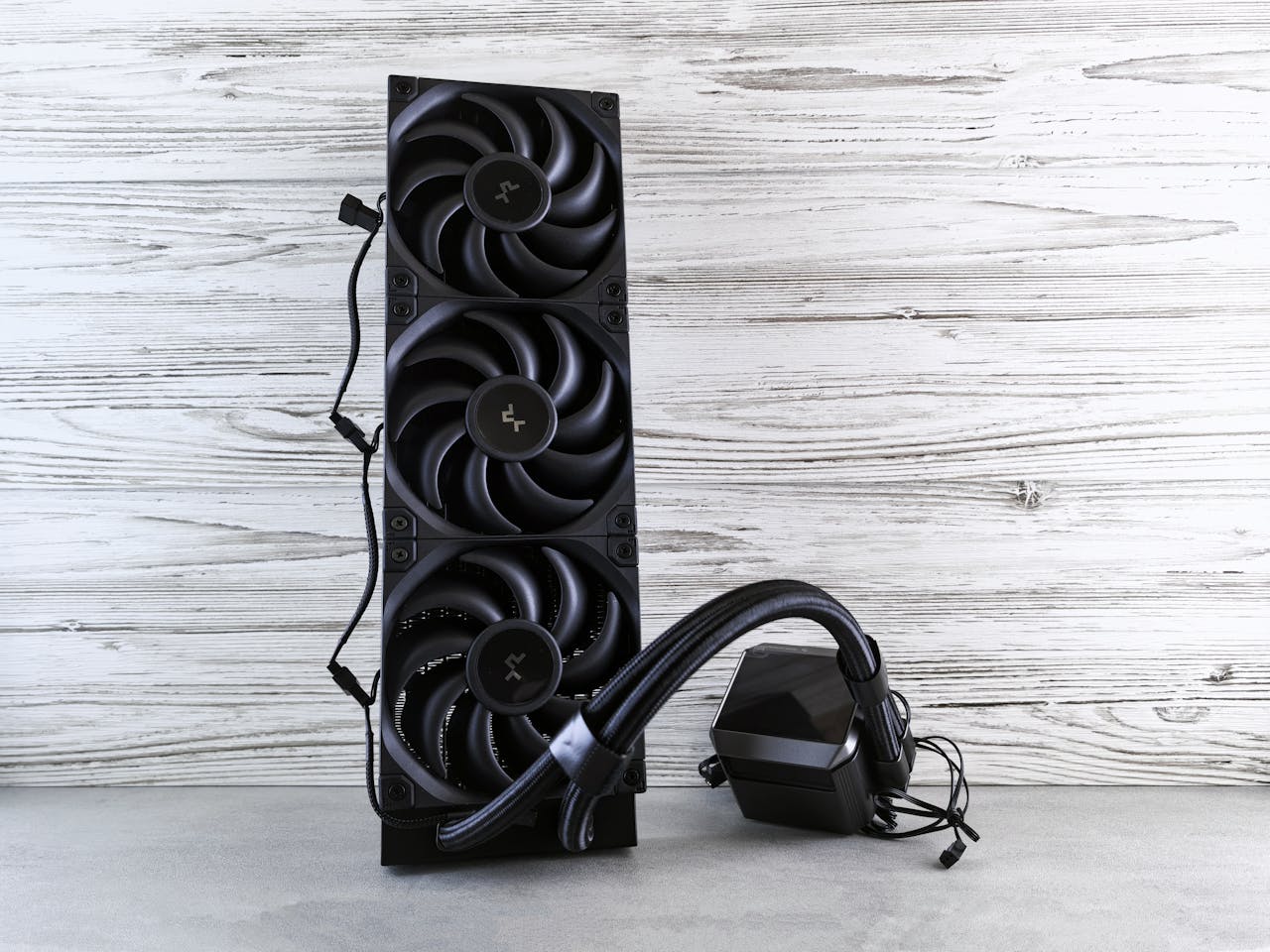 A high-performance cooling fan system for computers displayed on a wooden surface.